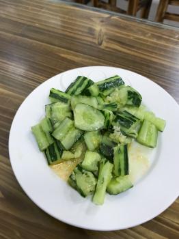 travel to China - chinese salad from fresh cucumbers in cheap eatery in Yangshuo town spring season