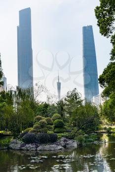 GUANGZHOU, CHINA - APRIL 1, 2017: pond in public garden in Zhujiang New Town of Guangzhou city in spring. Guangzhou is the third most-populous city in China with population about 13,5 mln