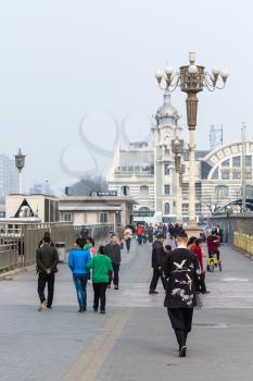 BEIJING, CHINA - MARCH 19, 2017: tourists walk to Zhengyangmen East Railway Station, branch of the China Railway Museum on Qianmen street. This building was opened as Beijing Railway Museum in 2008