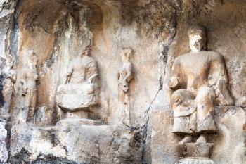 LUOYANG, CHINA - MARCH 20, 2017: carved statues in cave of Longmen Grottoes (Longmen Caves). The complex was inscribed upon the UNESCO World Heritage List in 2000