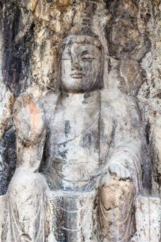 LUOYANG, CHINA - MARCH 20, 2017: carved sculpture in Longmen Grottoes (Longmen Caves). The complex was inscribed upon the UNESCO World Heritage List in 2000