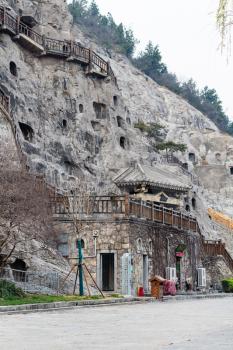 LUOYANG, CHINA - MARCH 20, 2017: road and carved slope in Chinese Buddhist monument Longmen Grottoes (Longmen Caves). The complex was inscribed upon the UNESCO World Heritage List in 2000