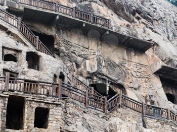 LUOYANG, CHINA - MARCH 20, 2017: caves and rooms in Chinese Buddhist monument Longmen Grottoes (Longmen Caves). The complex was inscribed upon the UNESCO World Heritage List in 2000