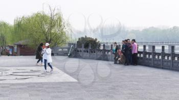 LUOYANG, CHINA - MARCH 20, 2017: people take photo in Chinese Buddhist monument Longmen Grottoes (Longmen Caves) in spring. The complex was inscribed upon the UNESCO World Heritage List in 2000