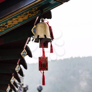 LUOYANG, CHINA - MARCH 20, 2017: bell on Xiangshan Temple on East Hill of Chinese Buddhist monument Longmen Grottoes in spring. The complex was inscribed upon the UNESCO World Heritage List in 2000