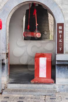 LUOYANG, CHINA - MARCH 20, 2017: bell in tower of Xiangshan Temple on East Hill of Chinese Buddhist monument Longmen Grottoes . The complex was inscribed upon the UNESCO World Heritage List in 2000