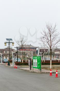 LUOYANG, CHINA - MARCH 20, 2017: parking square in area of Chinese Buddhist monument Longmen Grottoes (Dragon's Gate Grottoes, Longmen Caves) in valley Yi river in spring