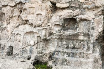 LUOYANG, CHINA - MARCH 20, 2017: carved slope of West Hill of Chinese Buddhist monument Longmen Grottoes. The complex was inscribed upon the UNESCO World Heritage List in 2000