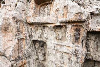 LUOYANG, CHINA - MARCH 20, 2017: carved sculptures in West Hill of Chinese Buddhist monument Longmen Grottoes. The complex was inscribed upon the UNESCO World Heritage List in 2000