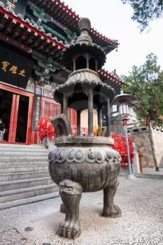 LUOYANG, CHINA - MARCH 20, 2017: altar in front of Xiangshan Temple on East Hill of Buddhist monument Longmen Grottoes in spring. The complex was inscribed upon the UNESCO World Heritage List in 2000