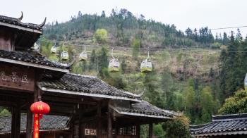 DAZHAI, CHINA - MARCH 23, 2017: cableway and gate of Dazhai Longsheng village in spring. This is central village in famous scenic area of Longji Rice Terraces in China