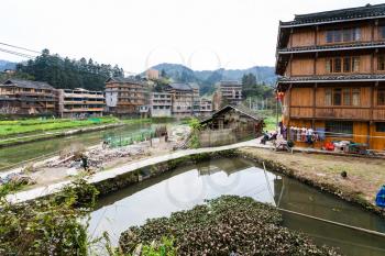 CHENGYANG, CHINA - MARCH 27, 2017: people on backyard of country house in Chengyang village of Sanjiang Dong Autonomous County in spring. Chengyang includes eight villages of the Dong people