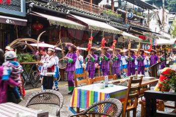 YANGSHUO, CHINA - MARCH 30, 2017: folk musicians on West Street in Yangshuo city in spring. Town is resort destination for domestic and foreign tourists because of scenic karst peaks