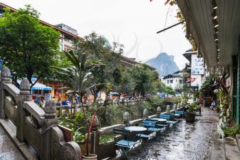 YANGSHUO, CHINA - MARCH 30, 2017: waterfront in Yangshuo town in spring. Town is resort destination for domestic and foreign tourists because of scenic karst peaks