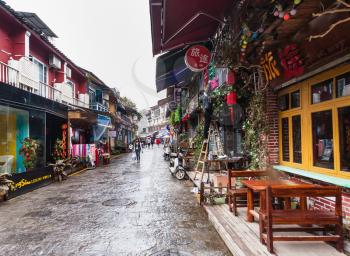 YANGSHUO, CHINA - MARCH 30, 2017: people on shopping street in Yangshuo city in spring. Town is resort destination for domestic and foreign tourists because of scenic karst peaks