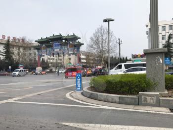 LUOYANG, CHINA - MARCH 20, 2017: people and cars on urban square in Luoyang city in spring. Luoyang had a population about 6,5 mln inhabitants with 1,9 mln people on the outskirts