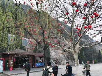 LUOYANG, CHINA - MARCH 20, 2017: tourists near in gift shop in area of Chinese Buddhist monument Longmen Grottoes (Longmen Caves). The complex was inscribed upon the UNESCO World Heritage List in 2000