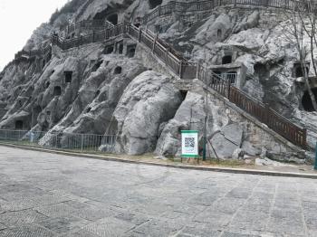 LUOYANG, CHINA - MARCH 20, 2017: carved caves in slope of West Hill in Chinese Buddhist monument Longmen Grottoes (Longmen Caves). The complex was inscribed upon the UNESCO World Heritage List in 2000