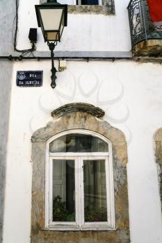 Travel to Algarve Portugal - window of old urban house on street Rue da Igreja in Estoi town