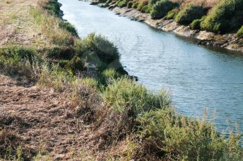 Travel to Algarve Portugal - riverbank of Ribeira de Quarteira river near beach praia da rocha baixinha nascente in vilamoura area