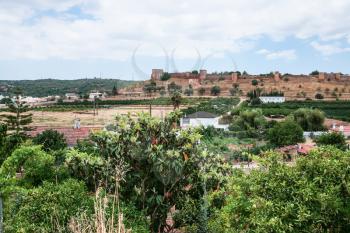Travel to Algarve Portugal - view of Castle of Silves (Castelo de Silves) from rural gardens in Silves city