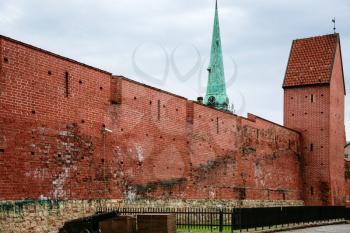 travel to Latvia - red walls and the Ramer tower of restored section of Riga Old City Walls on Torna street in autumn