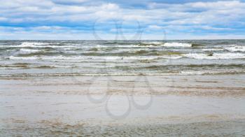 travel to Latvia - rainy clouds over beach of Gulf of Riga of Baltic Sea in seaside resort Jurmala town in autumn