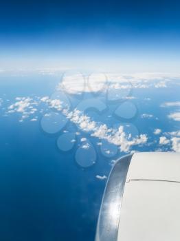 View from the airplane - turbine of aircraft and view of сlouds chain over blue Aegean Sea in Greece in autumn