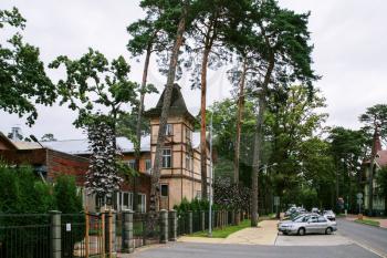 JURMALA, LATVIA - SEPTEMBER 13, 2008: residential country houses on street in Jurmala city in autumn. Jurmala is seaside resort town stretching 32 km on coast of Gulf of Riga of Baltic Sea