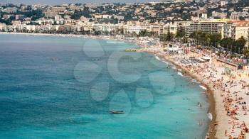 NICE, FRANCE - JULY 6, 2008: above view of people on urban beach, Promenade des Anglais and hotel and apartment houses of Nice city on Cote d'Azur (Coast of Azure) of French Riviera in summer