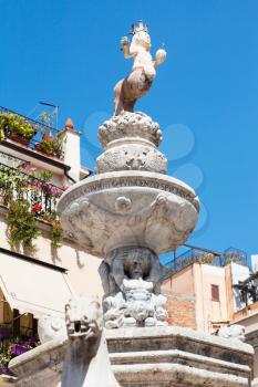 travel to Sicily, Italy - figure of baroque style fountain (4 Fontane of Taormina) on Piazza Del Duomo in Taormina city in summer day