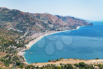travel to Sicily, Italy - above view of Letojanni resort town of beach of Ionian Sea from Taormina city in summer day