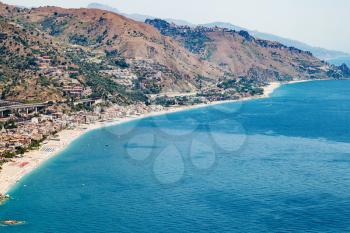 travel to Sicily, Italy - above view of Letojanni resort town of coast of Ionian Sea from Taormina city in summer day
