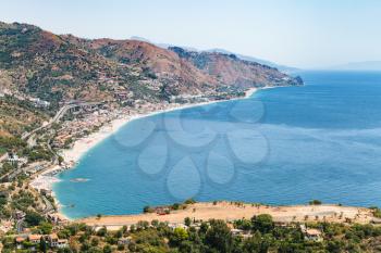 travel to Sicily, Italy - above view of Letojanni resort village of beach of Ionian Sea from Taormina city in summer day