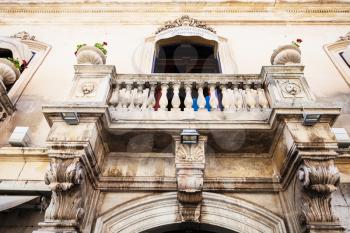 TAORMINA, ITALY - JUNE 29, 2017: facade of medieval palace on main street Corso Umberto I in Taormina city. Taormina is resort town on Ionian Sea in Sicily