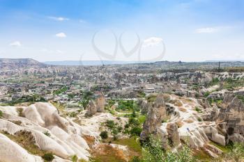 Travel to Turkey - above view of rock houses and Goreme town from mountain in Cappadocia in spring