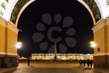 view of Palace Square with Alexander Column and Winter Palace through Triumphal Arch in Saint Petersburg city in night