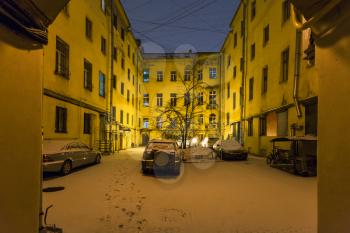 view of urban yard in St Petersburg city in night snowfall
