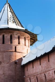 red wall and tower of Monastery of Our Savior and St Euthymius in Suzdal town in winter in Vladimir oblast of Russia