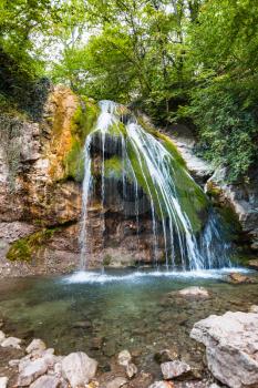 travel to Crimea - Djur-djur waterfall and lake on Ulu-Uzen river in Haphal Gorge of Habhal Hydrological Reserve natural park in Crimean Mountains in autumn.
