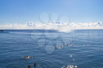 travel to Crimea - swimming tourists in Black Sea near urban beach in Alushta city in morning