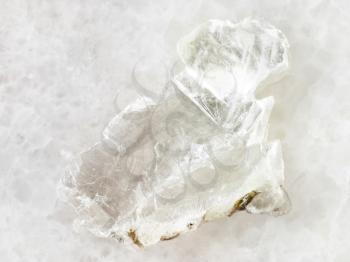 macro shooting of natural mineral rock specimen - raw layer of Brucite stone (Magnesium oxide ore) on white marble background from Sverdlovsk Region, Urals, Russia