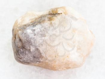 macro shooting of natural mineral rock specimen - raw marble stone on white marble background from Greece