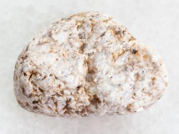 macro shooting of natural mineral rock specimen - white Granite stone on white marble background