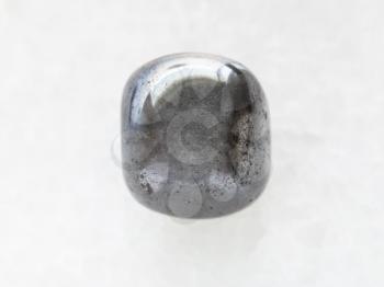macro shooting of natural mineral rock specimen - polished hematite stone on white marble background