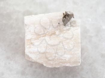 macro shooting of natural mineral rock specimen - rough Gypsum stone on white marble background