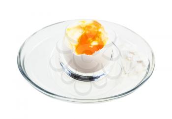 open boiled white egg in glass egg cup isolated on white background