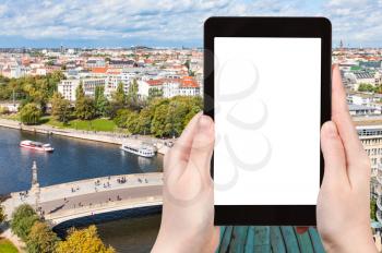 travel concept - tourist photographs Berlin cityscape with Spree River in Germany in september on tablet with cut out screen for advertising logo