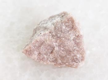 macro shooting of natural mineral rock specimen - rough dolomite stone on white marble background