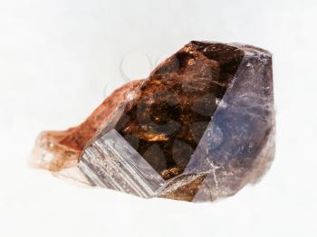 macro shooting of natural mineral rock specimen - rough crystal of smoky quartz gemstone on white marble background